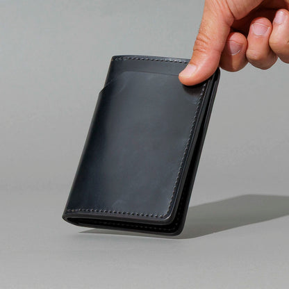 One-Off Traveler Passport Holder in Black Shell Cordovan with Red Pentagram Embroidery, held in hand, shot 2