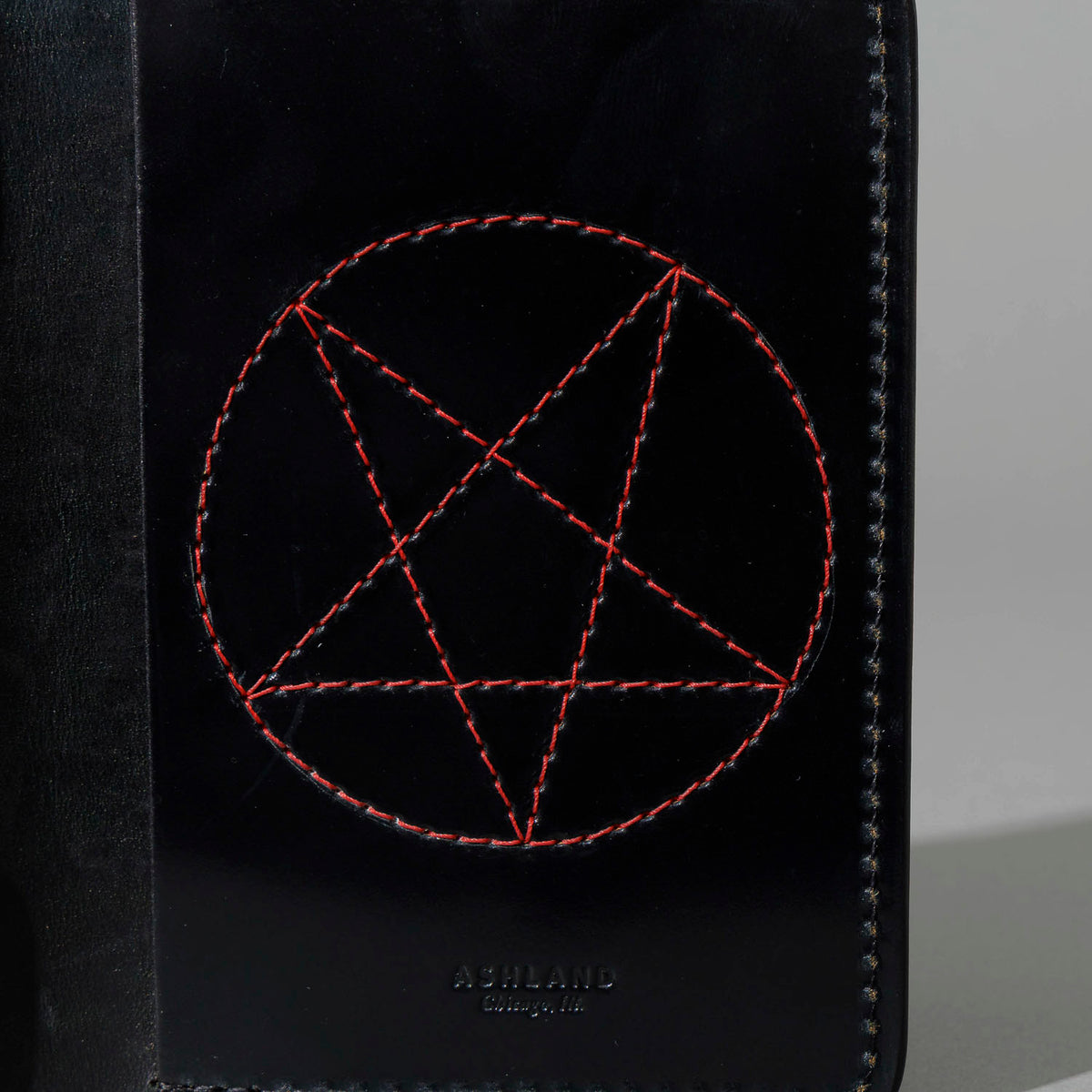 One-Off Traveler Passport Holder in Black Shell Cordovan with Red Pentagram Embroidery, close-up of the embroidery, shot 1