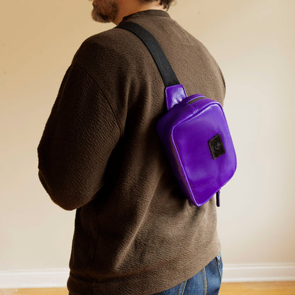 One-Off Sling Bag in Violet Latigo, worn crossbody by a model, shot 1