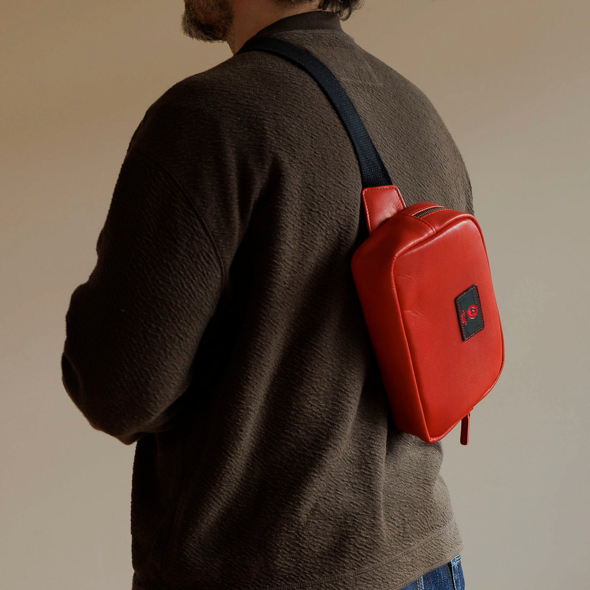 One-Off Sling Bag in Red Latigo, worn crossbody by a model, shot 1