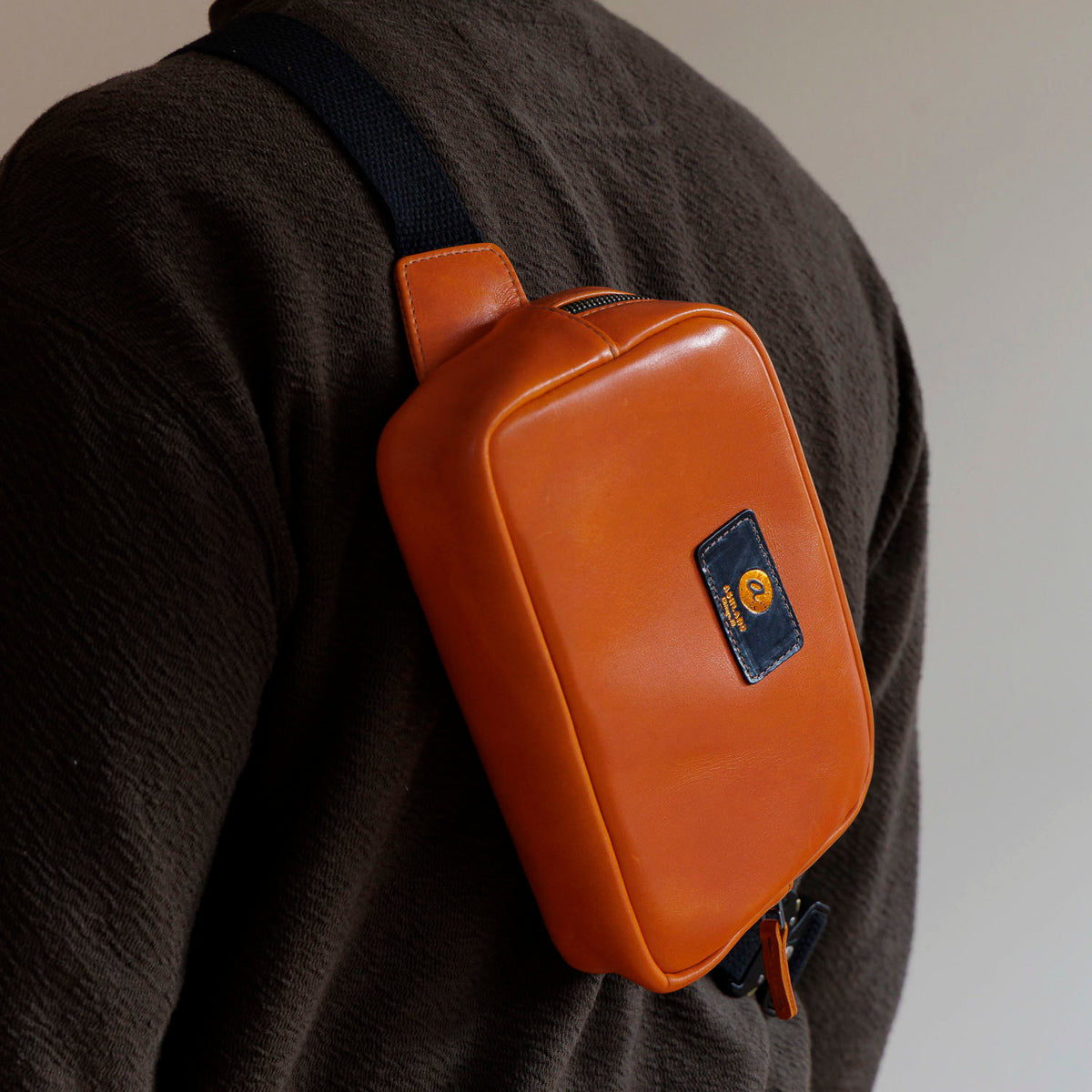 One-Off Sling Bag in Orange Latigo, worn crossbody by a model, shot 2