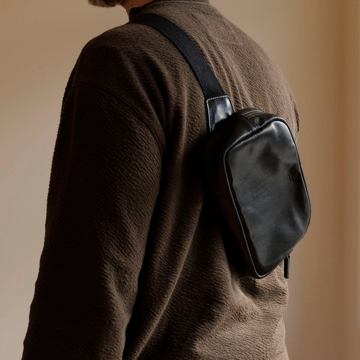 Sling Bag in Black Aspen Horsehide, worn crossbody by a model, shot 2