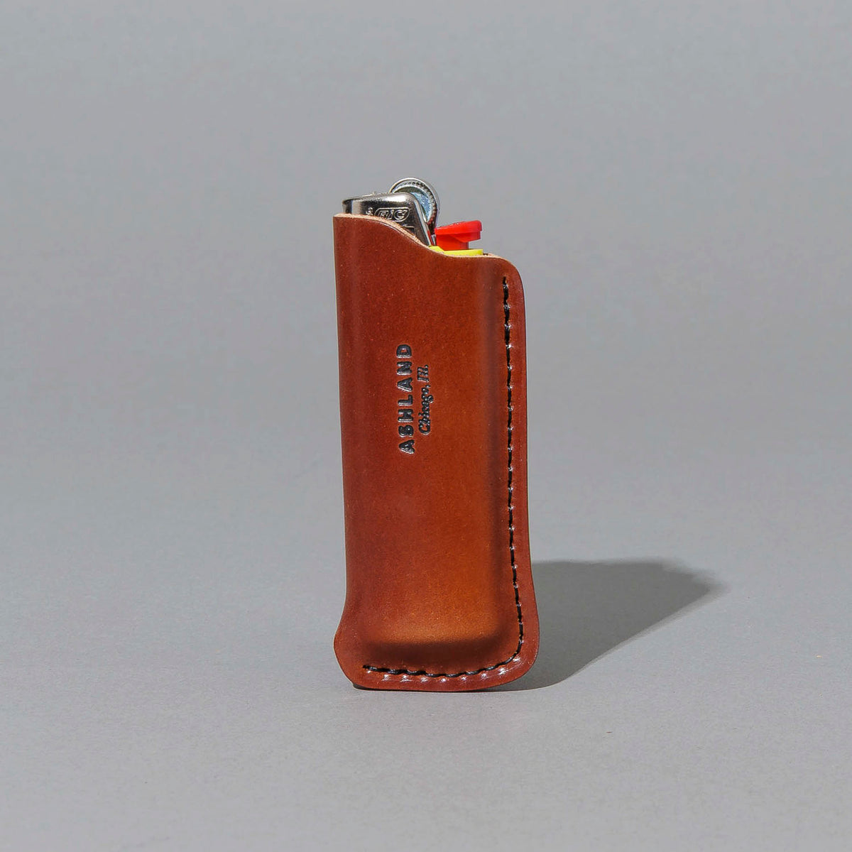 One-Off Lighter in Blood Orange Shell Cordovan, standing upright, side angle, shot 1