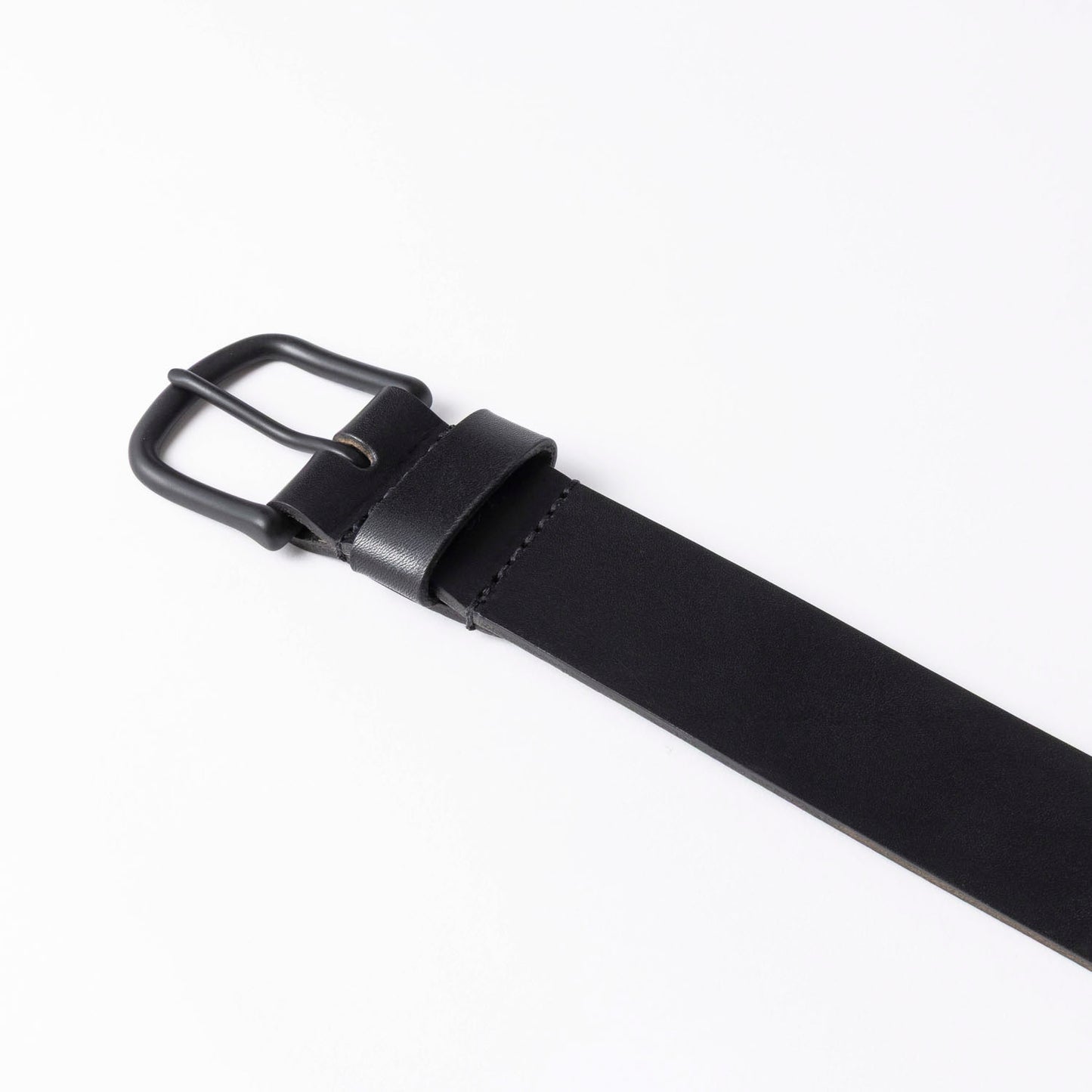 Black leather belt with a black buckle on a white background
