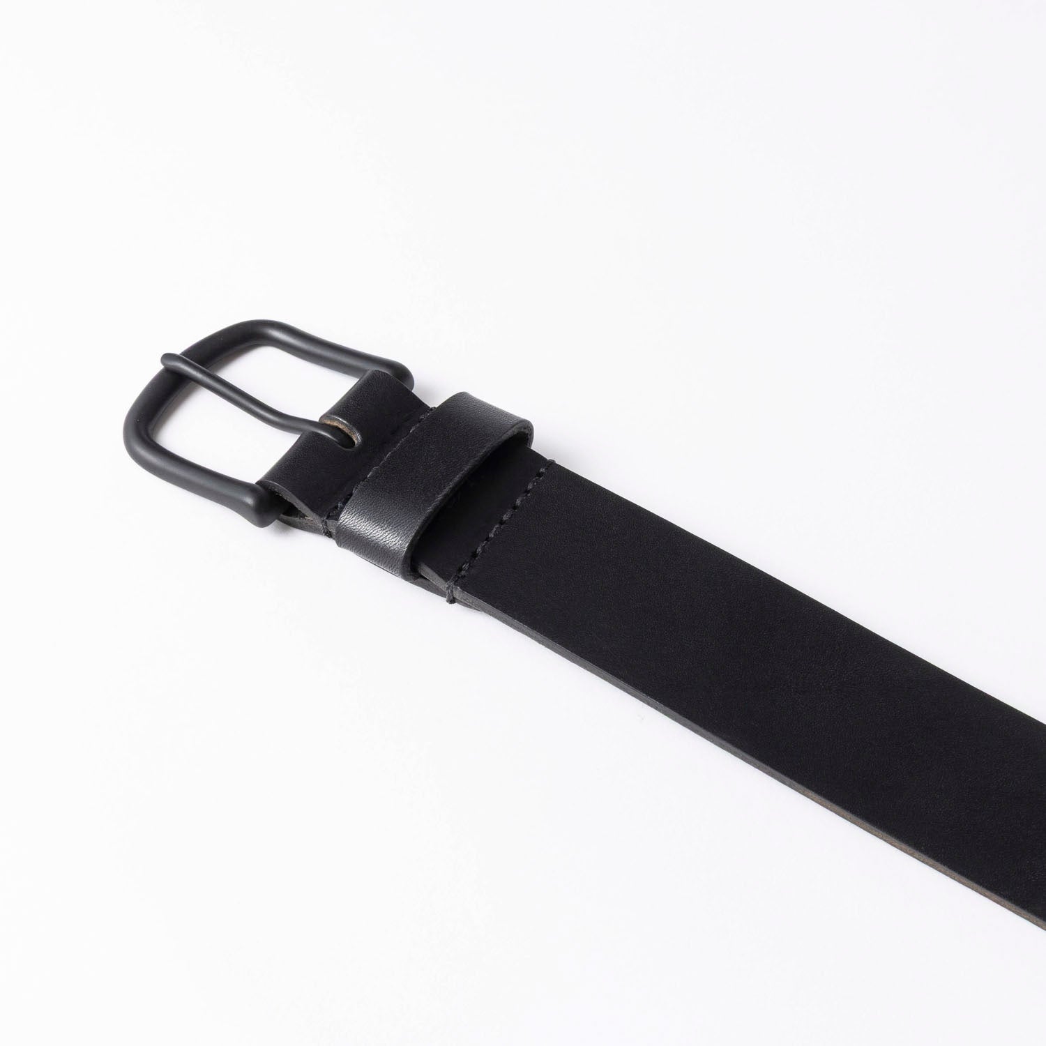 Black leather belt with a black buckle on a white background