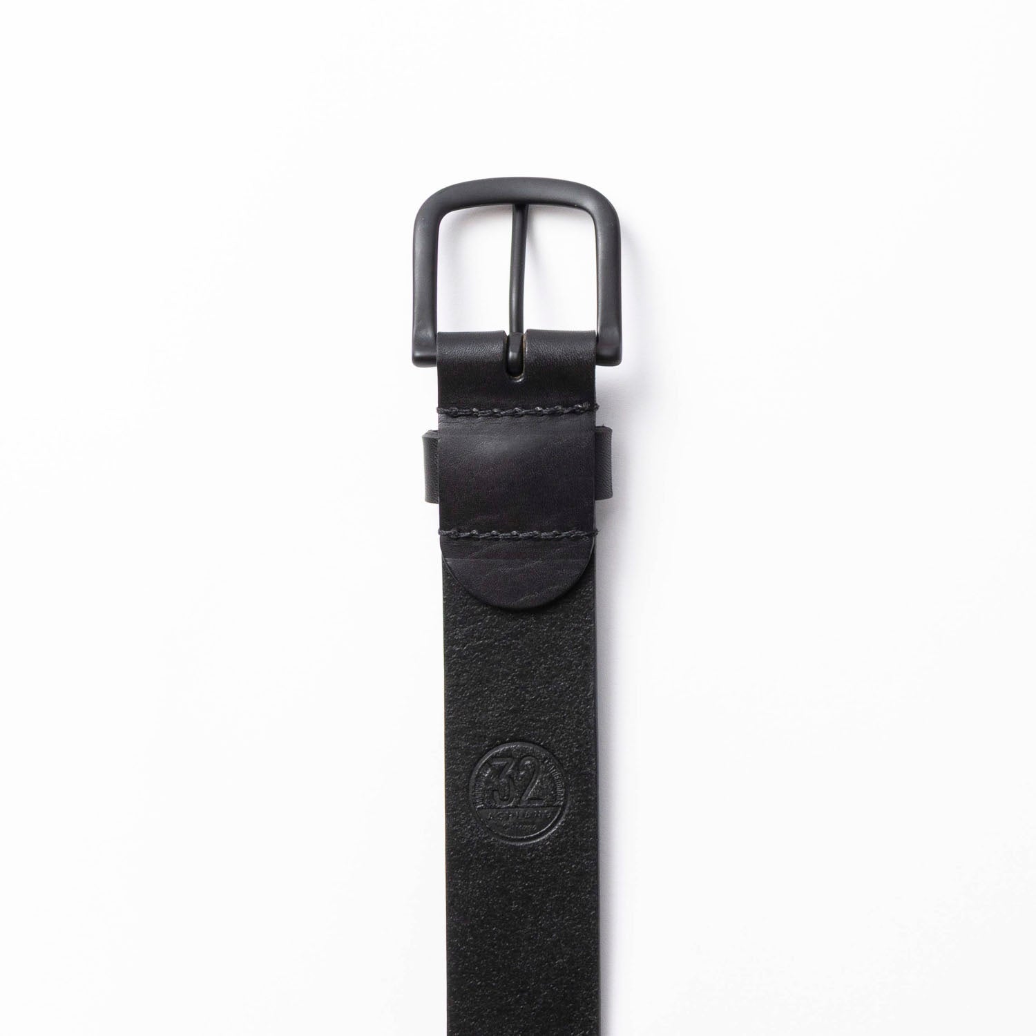 Black leather belt with a black buckle on a white background