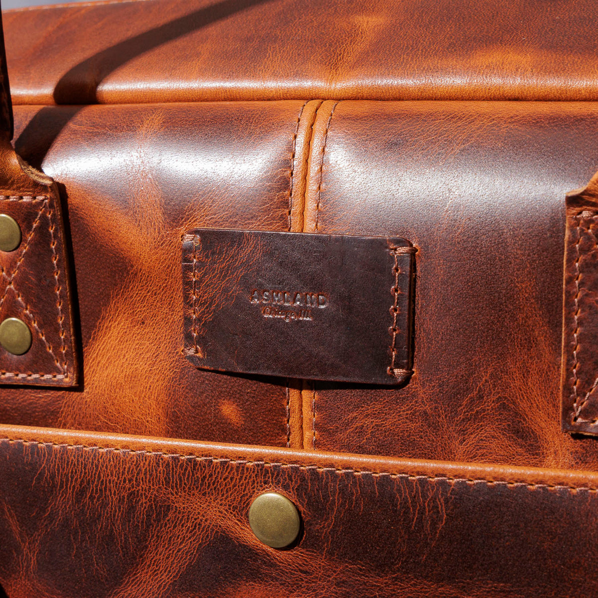 Close-up of the Ashland Leather brand patch on the LaSalle Briefcase