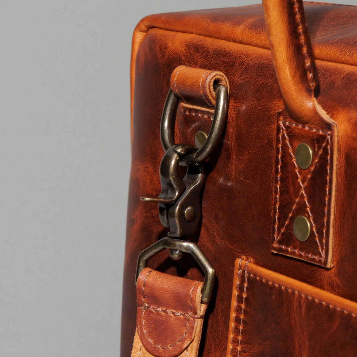 Close-up of the front pocket hardware clip on the Ashland Leather LaSalle Briefcase