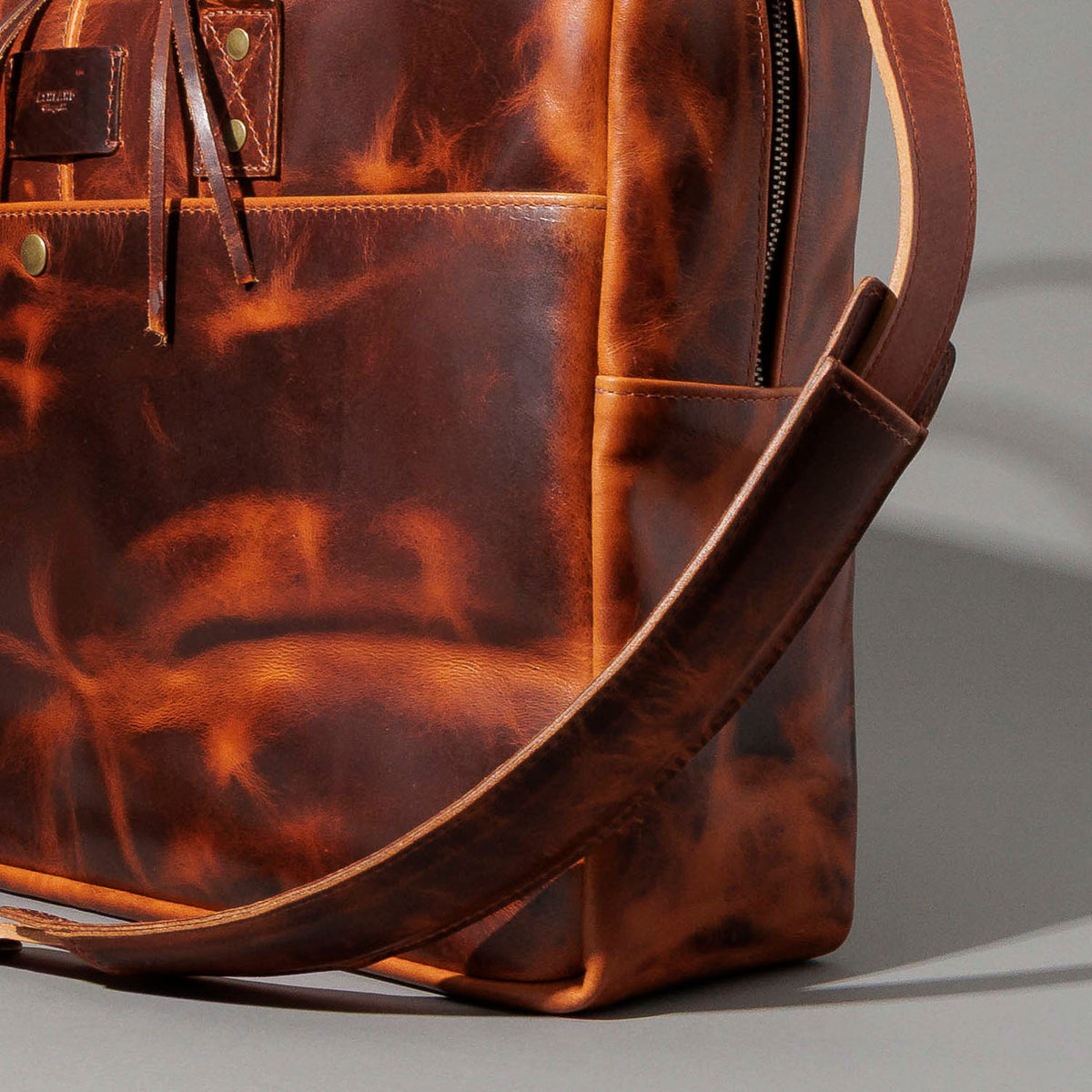 Ashland Leather LaSalle Briefcase, side view product shot with strap draped