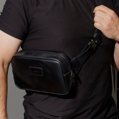 Retrieving keys from the exterior back pocket of the Ashland Leather Sling Bag