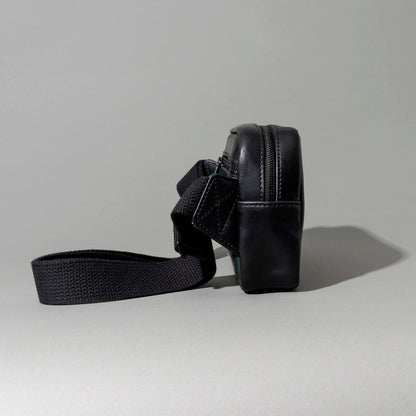 Back view of the Ashland Leather Sling Bag showing the exterior pocket and strap laid flat