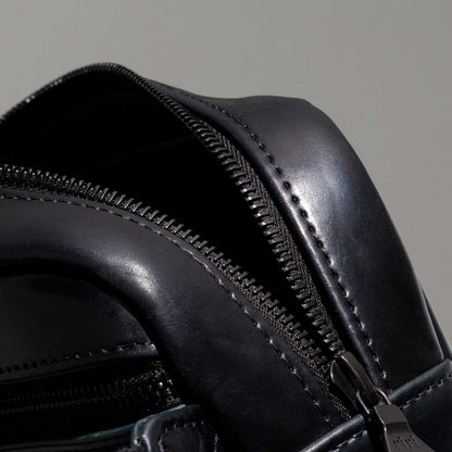 Close-up of the top handle and strap hardware clip on the Ashland Leather Sling Bag