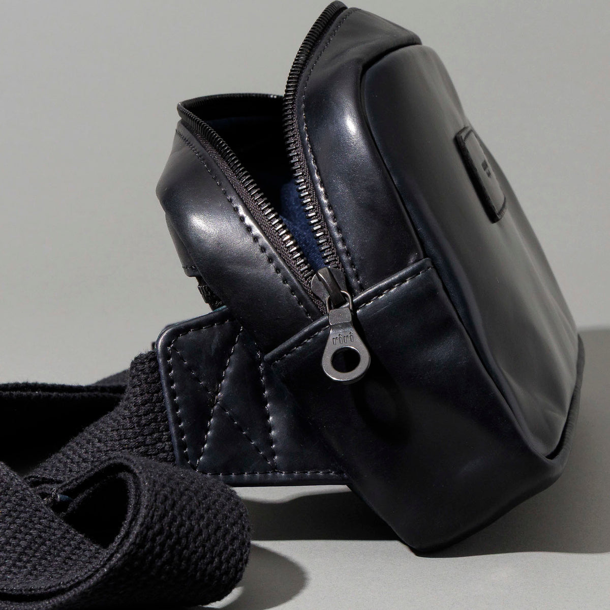 Close-up of the empty interior compartment and navy lining of the Ashland Leather Sling Bag