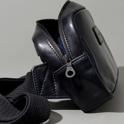 Close-up of the empty interior compartment and navy lining of the Ashland Leather Sling Bag