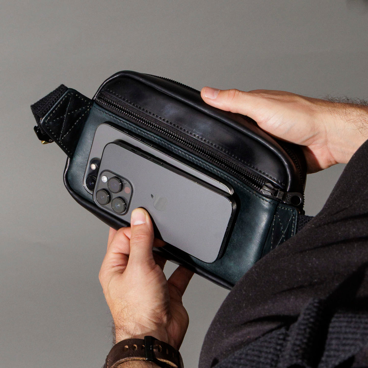 Securing the Ashland Leather Sling Bag while worn crossbody