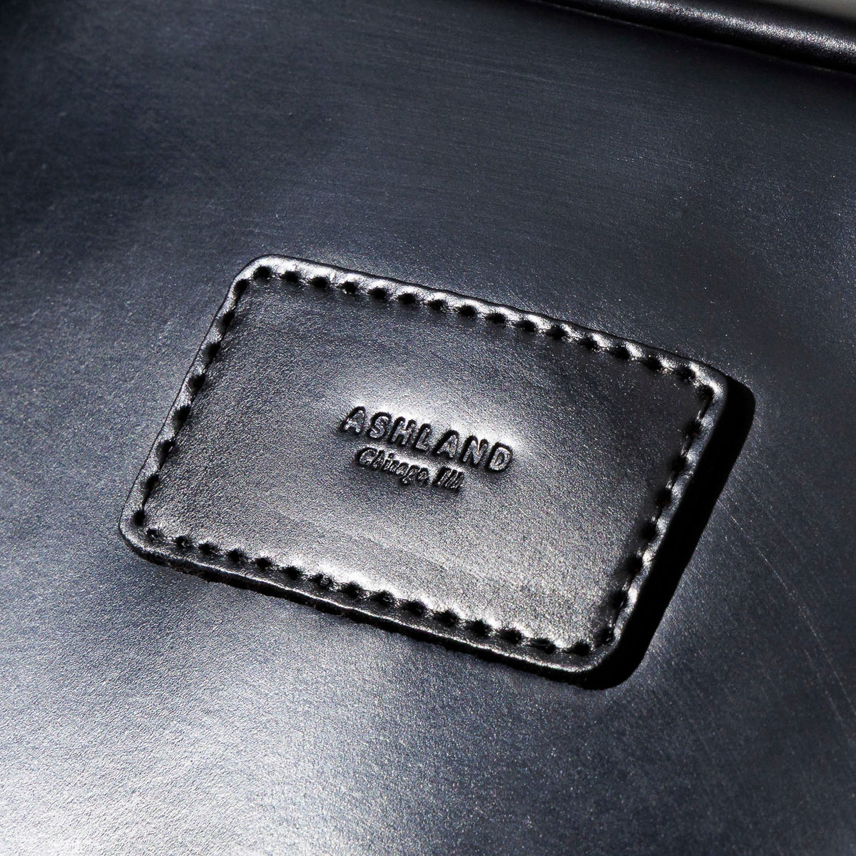 Close-up side profile of the curved edge and stitching on the Ashland Leather Sling Bag