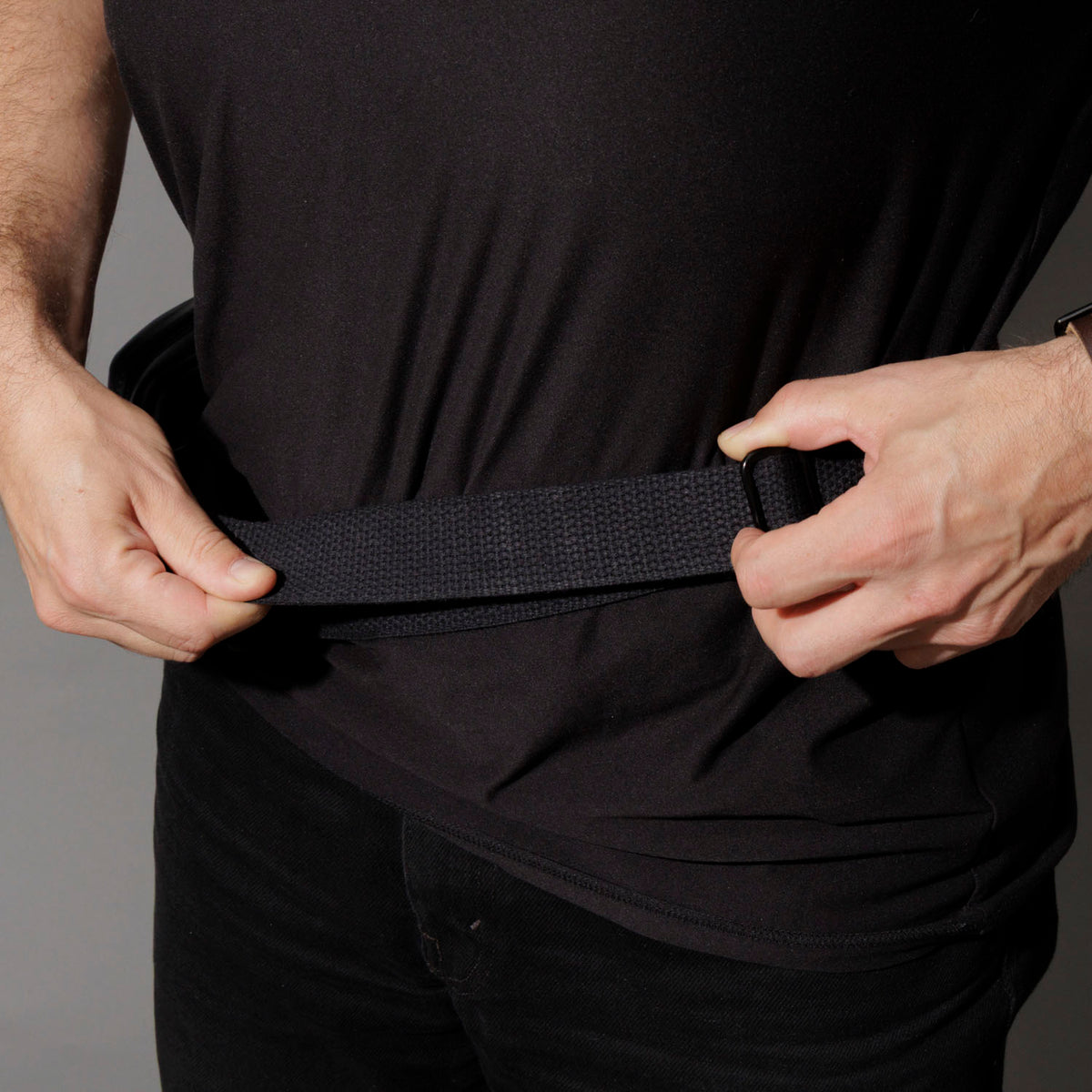Adjusting the crossbody strap buckle on the Ashland Leather Sling Bag at the hip