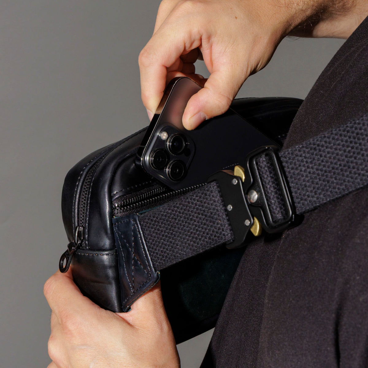 Centering the adjustable strap of the Ashland Leather Sling Bag across the chest