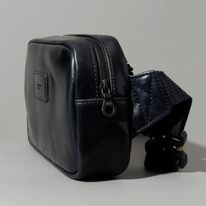 Close-up of the adjustable webbing strap and hardware on the Ashland Leather Sling Bag
