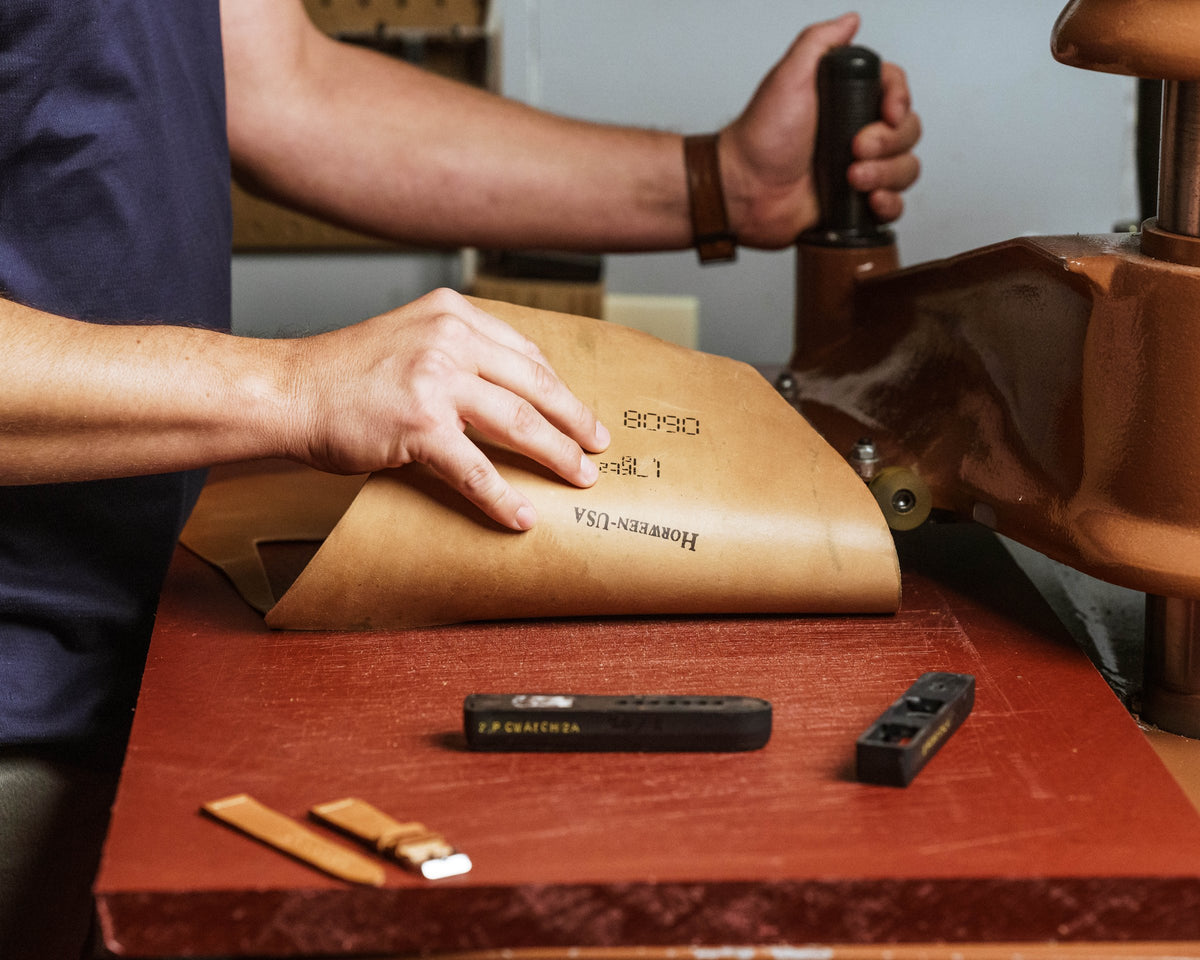Ashland Leather craftsman hand stitching Horween® leather at the Chicago workshop bench
