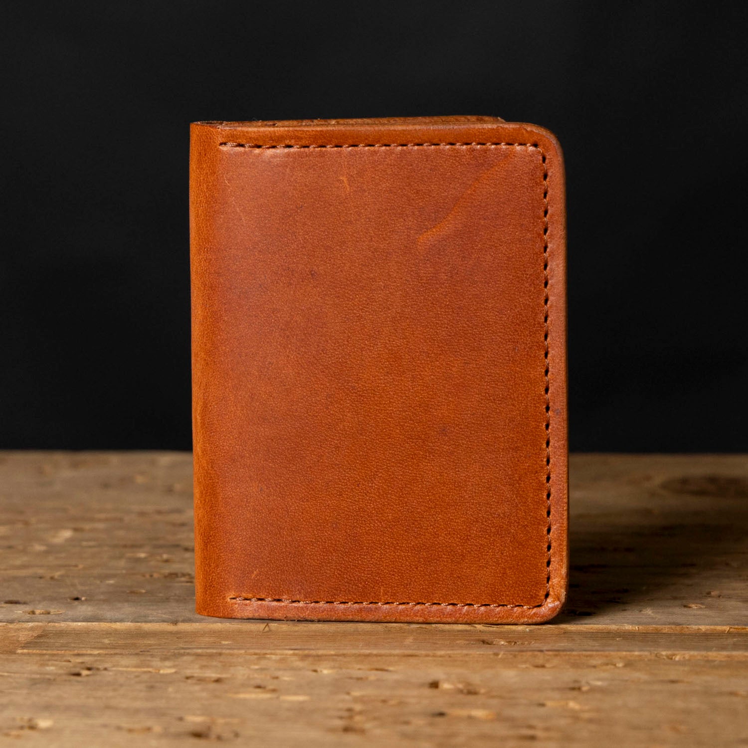 A brown leather wallet with visible stitching
