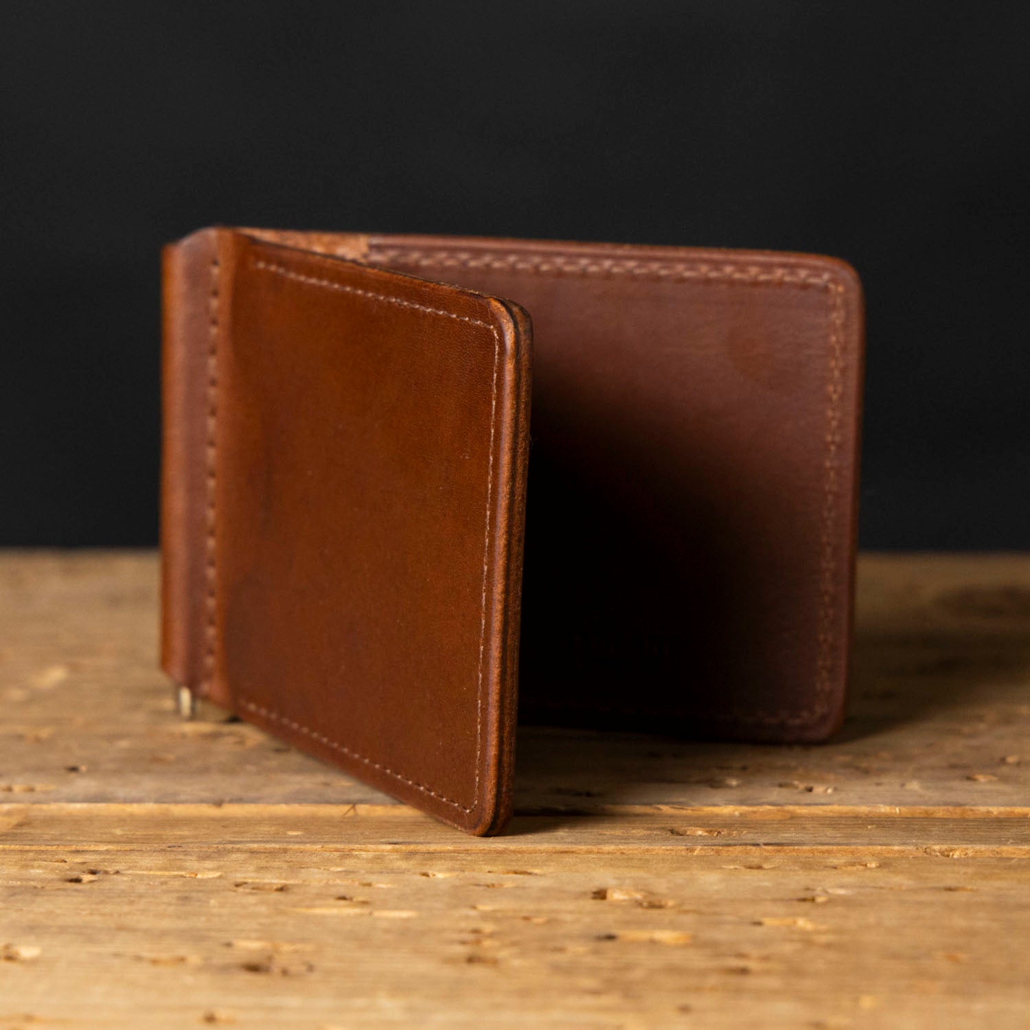 Capone Money Clip shown on worn workbench