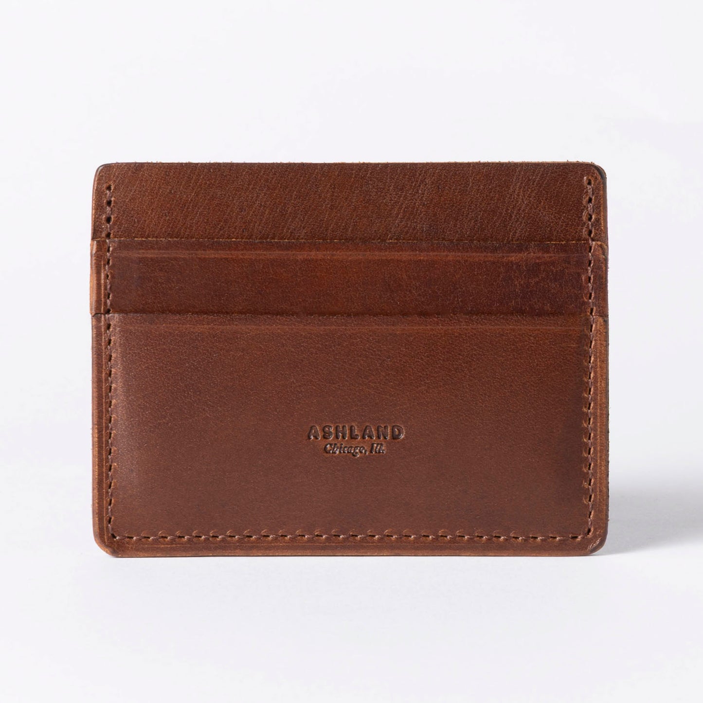Brown leather cardholder with 'Ashland' branding on a white background