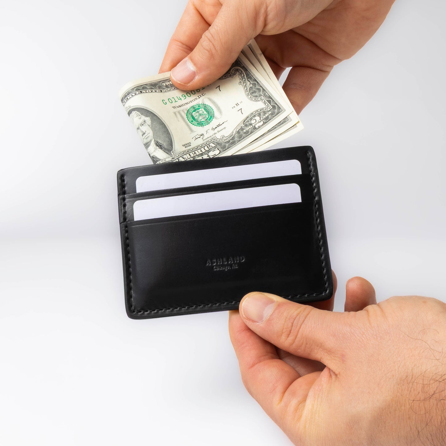 Black wallet with money and cards on a white background