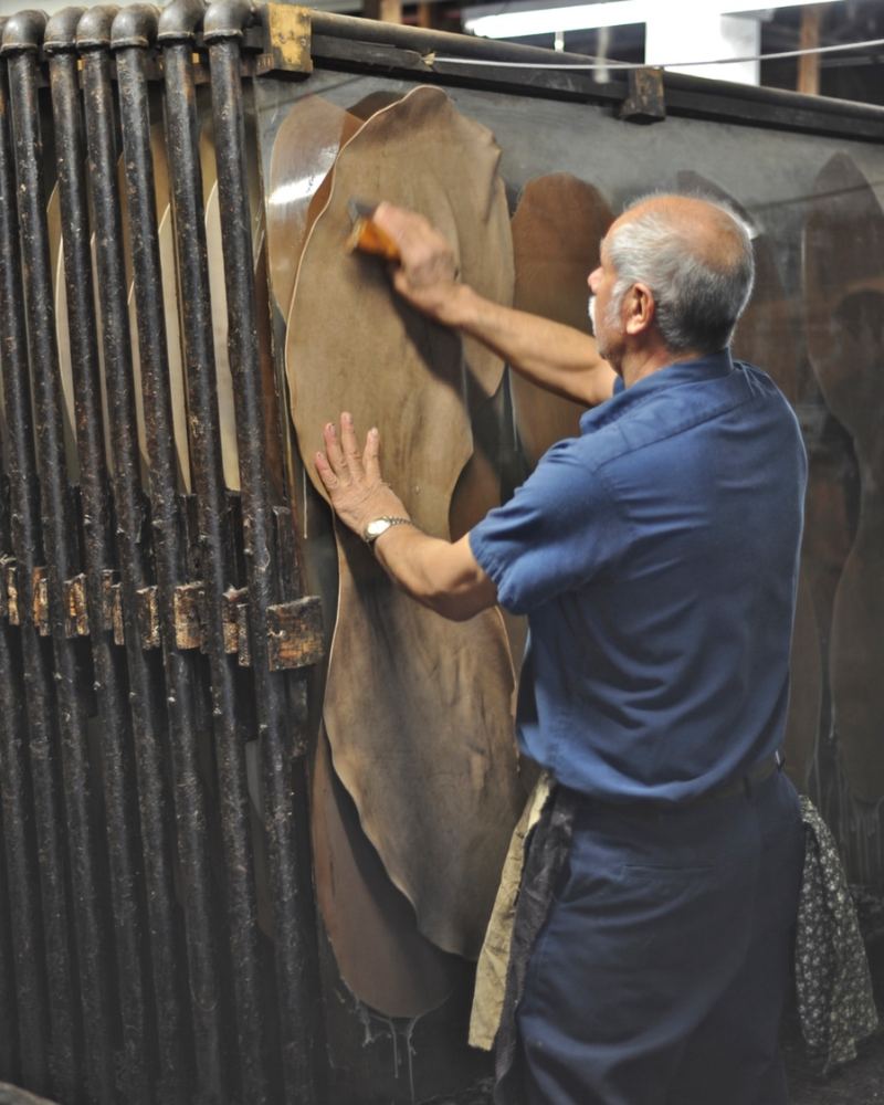 A worker setting a hide on a rack at the Horween® tannery, Chicago