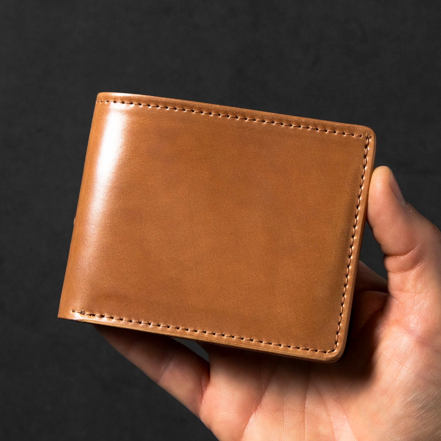 Johnny the Fox wallet in craftsman's hand