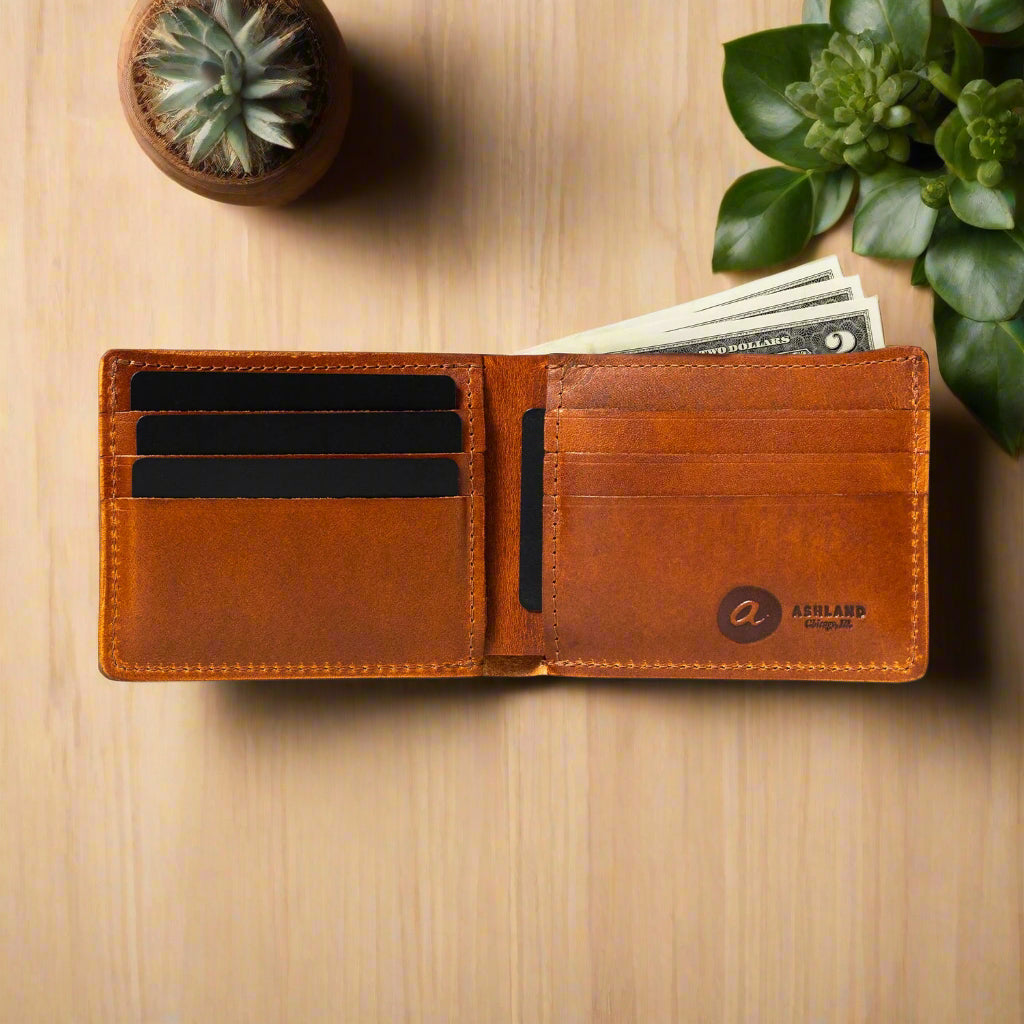 Brown leather wallet with card slots on a wood table