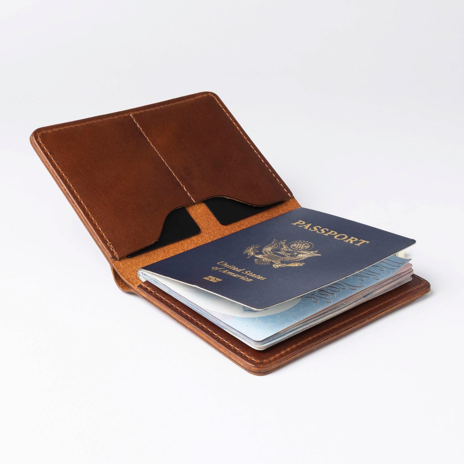 Brown leather passport holder with a passport inside on a white background