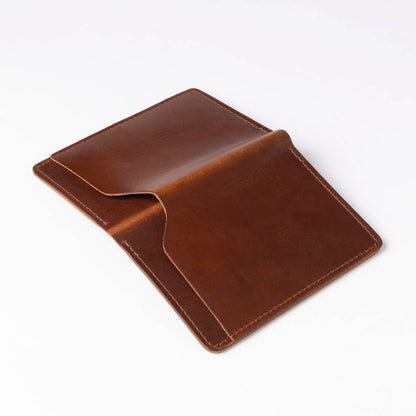 Brown leather passport holder on a white background