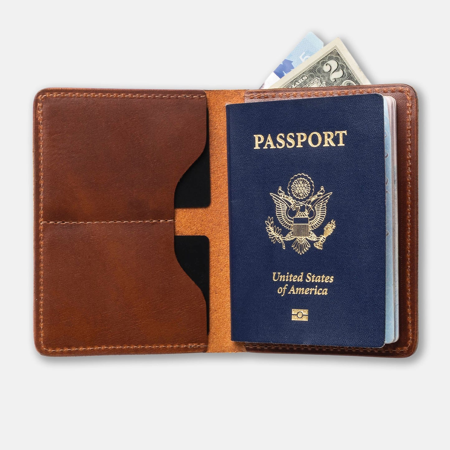 Brown leather passport holder with a US passport and money on a white background