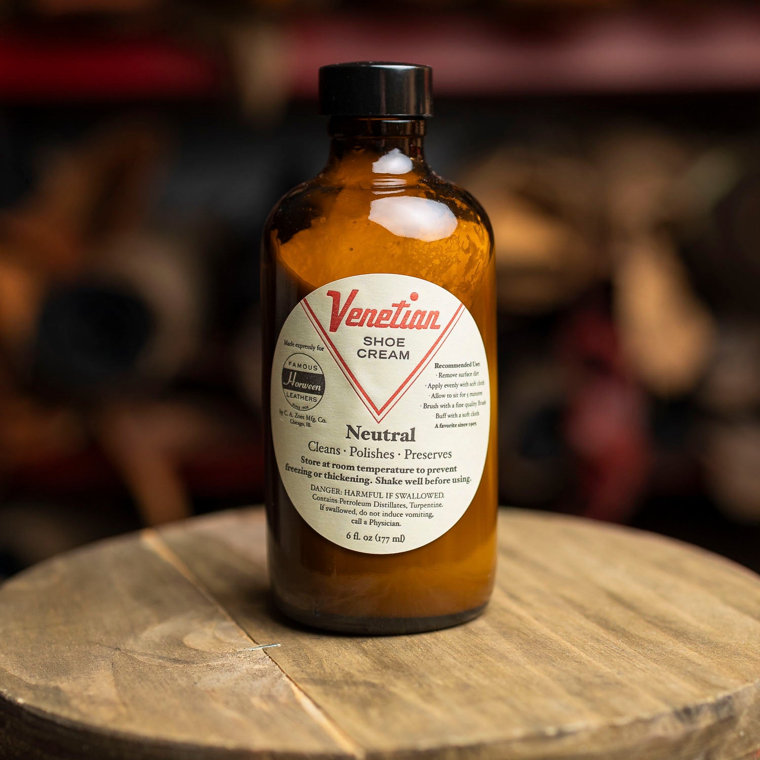 Venetian Shoe Cream bottle on a wooden surface with a blurred background