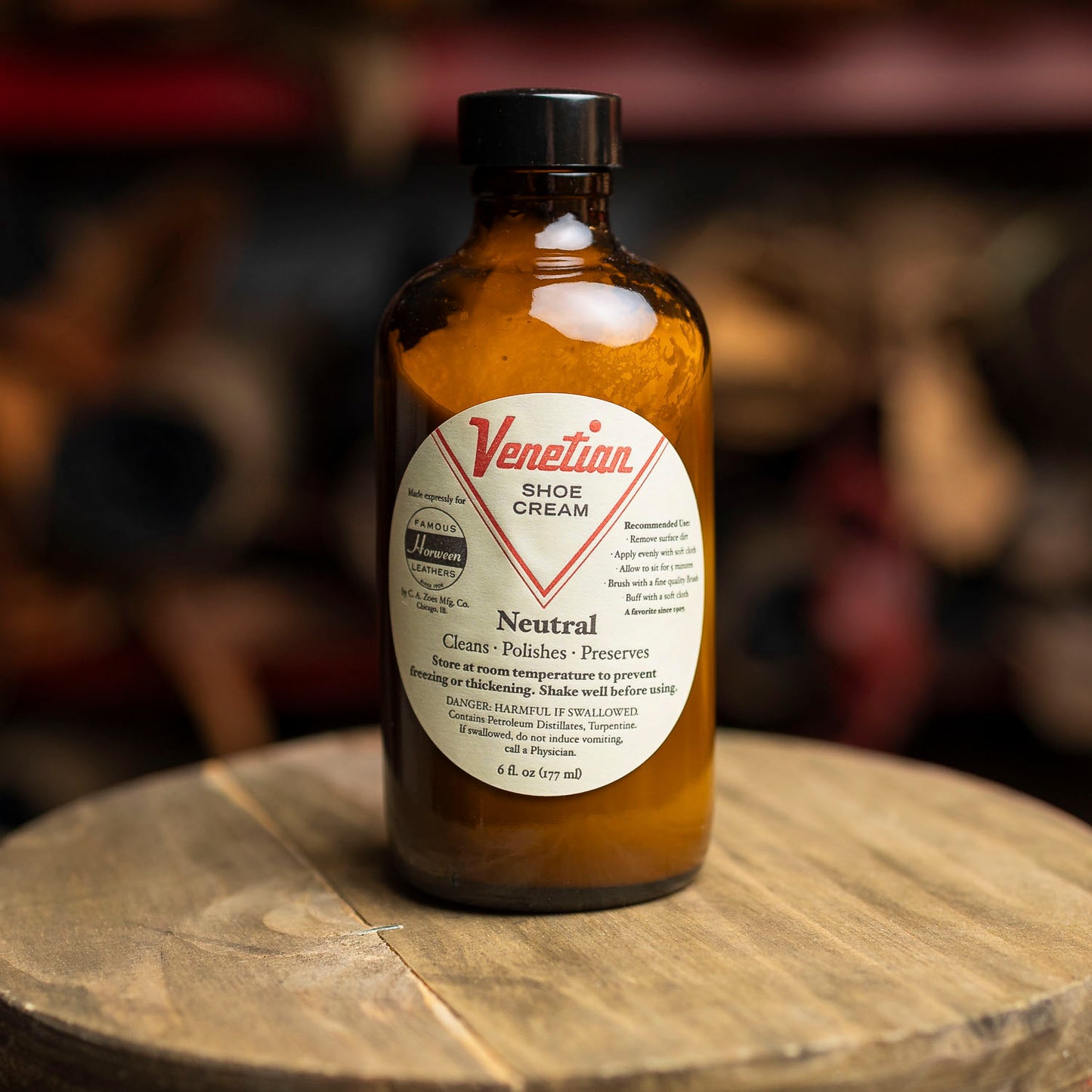 Venetian Shoe Cream bottle on a wooden surface with a blurred background