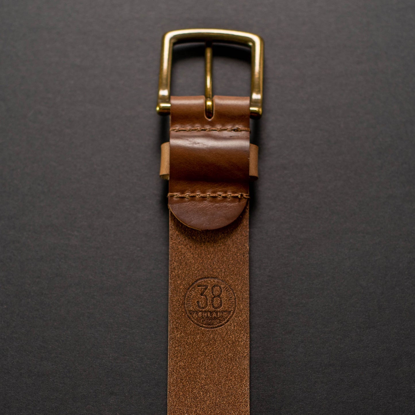 Vertical image of Ashland chromexcel belt, back of belt buckle with leather grain and size 38 stamp