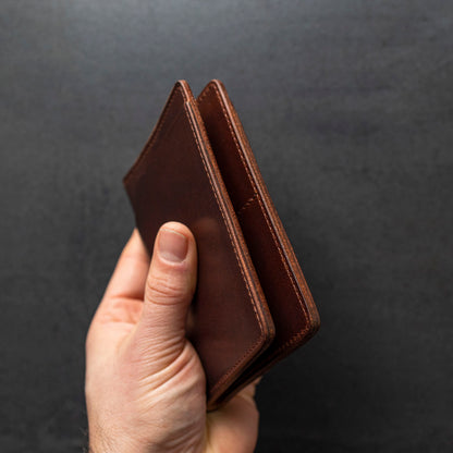 Hand showing edge workmanship of Cypress Fat Herbie men's wallet