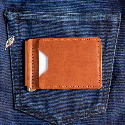 A Capone Money clip sitting on selvedge jeans with a white credit card visible