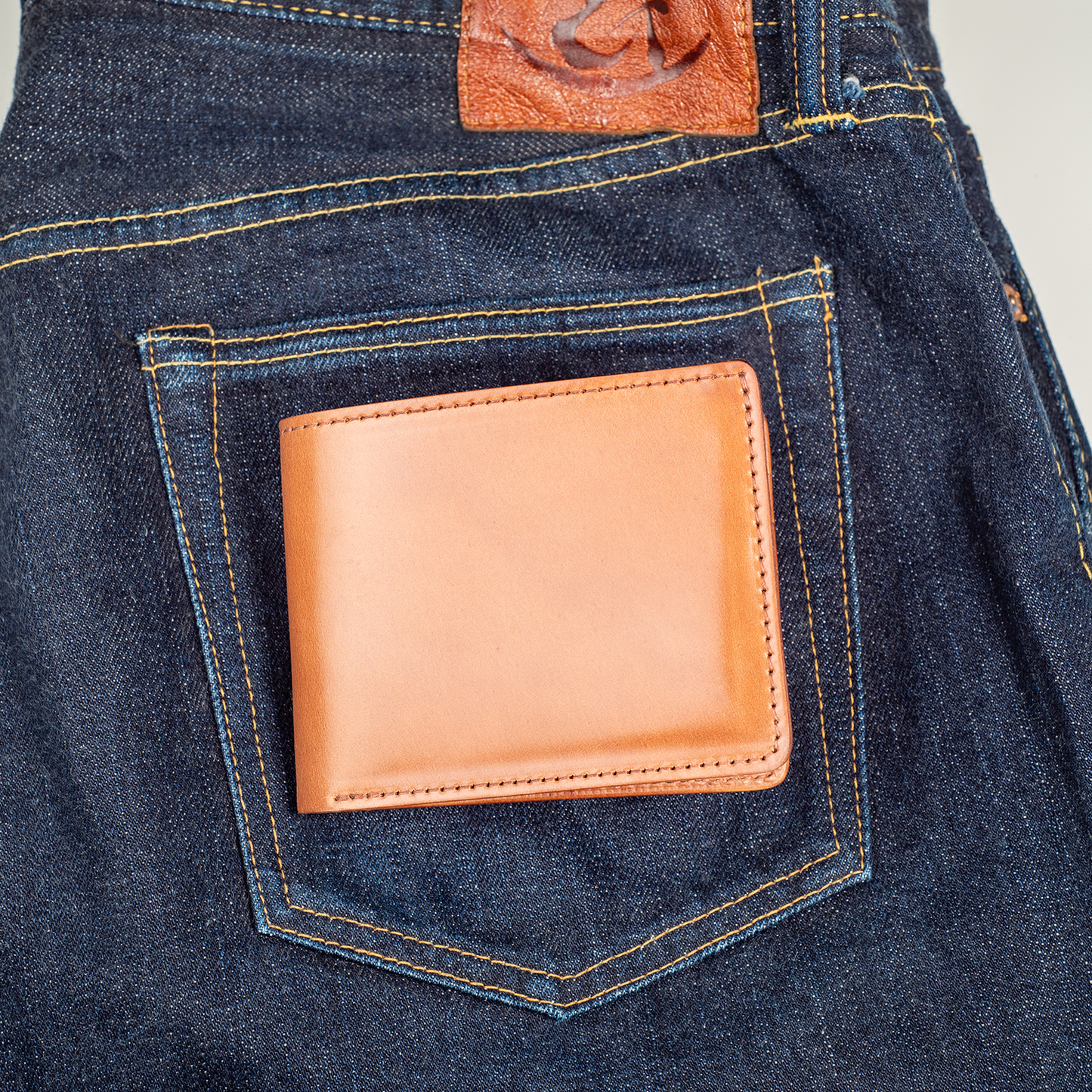 men's wallet shown on blue denim