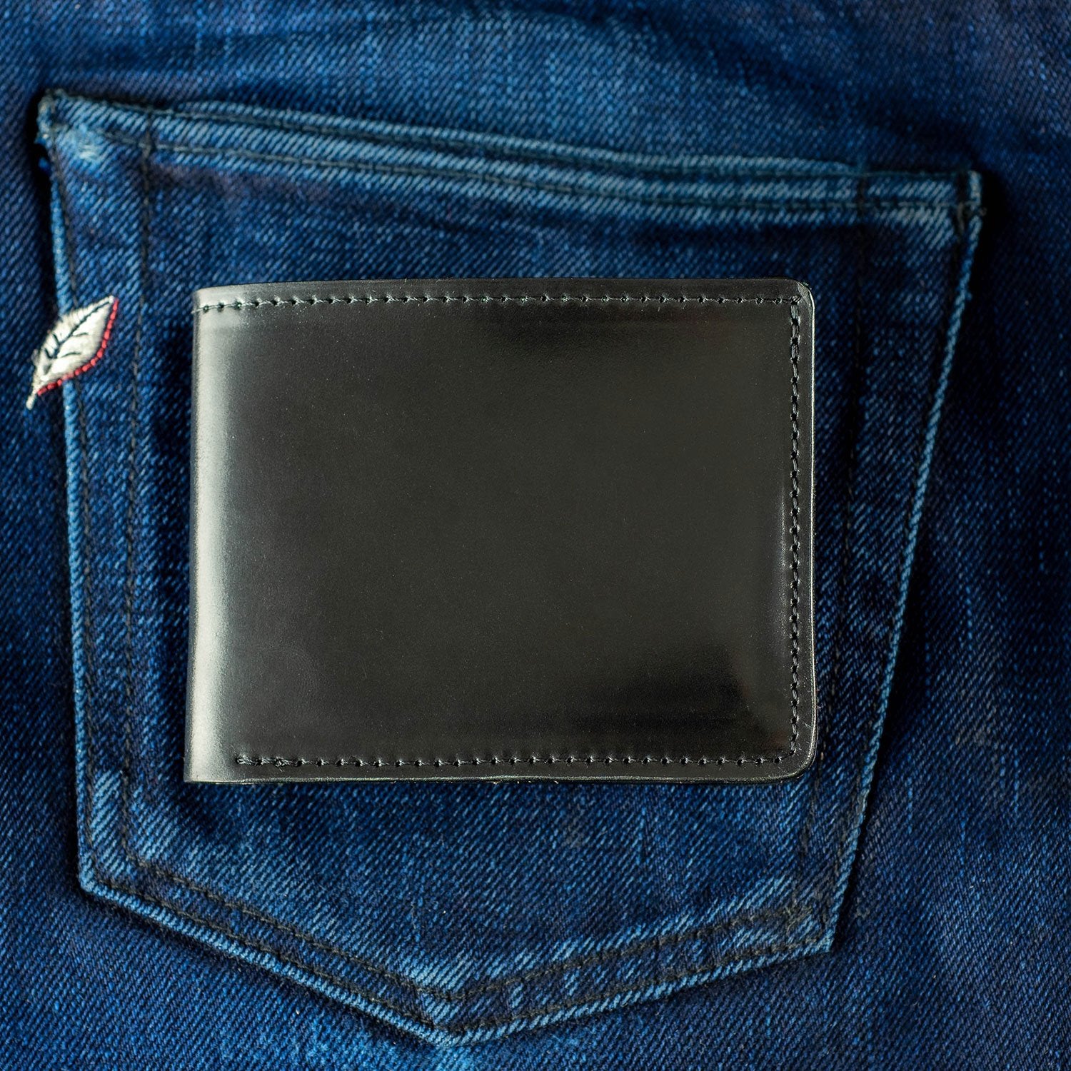 shell cordovan leather wallet displayed on blue selvedge denim