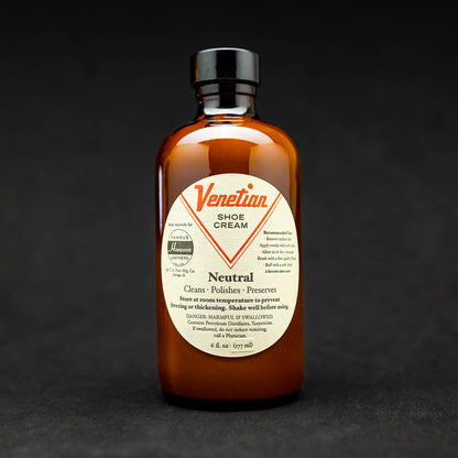 Bottle of venetian shoe cream, dark background